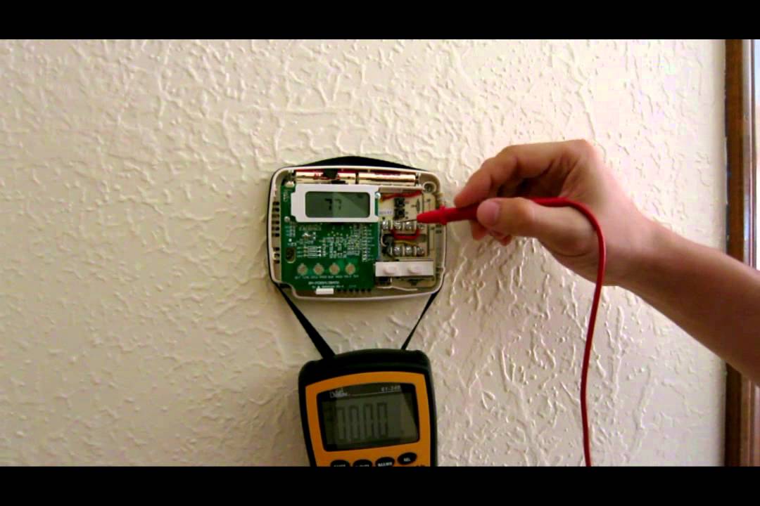 a technician checking thermostat