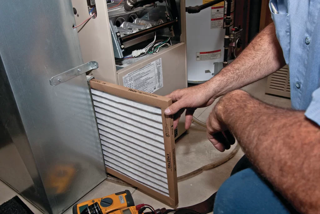a person taking out furnace filters