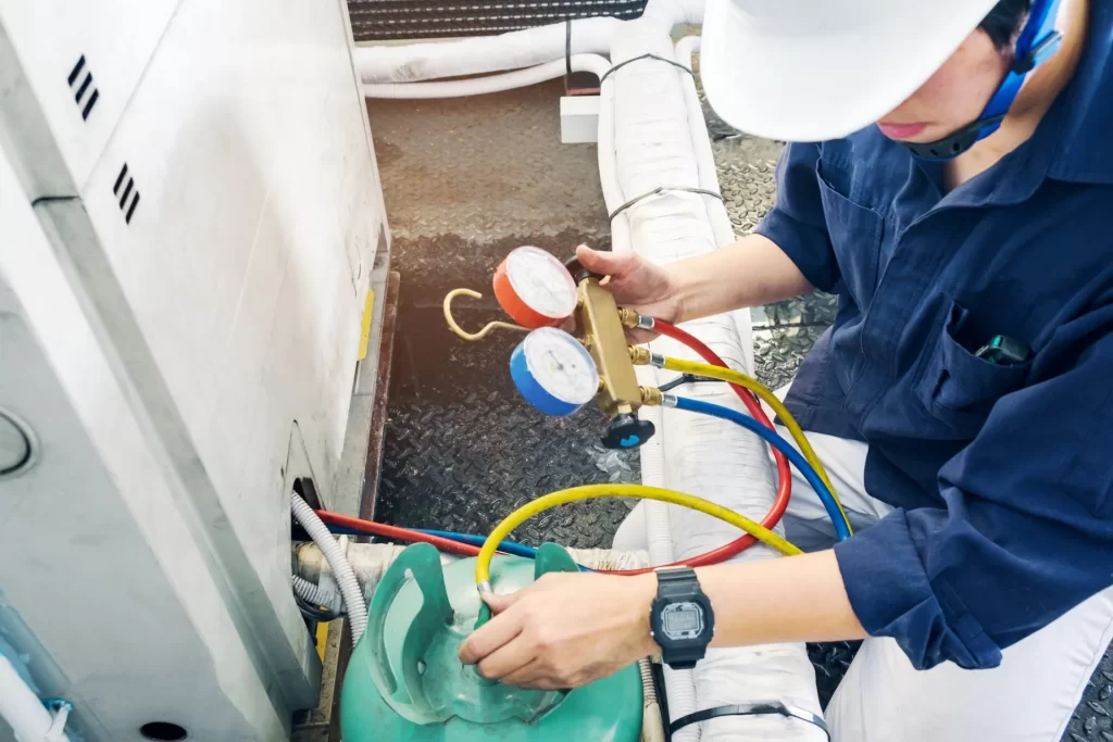 a person checking gas pressure of hvac system