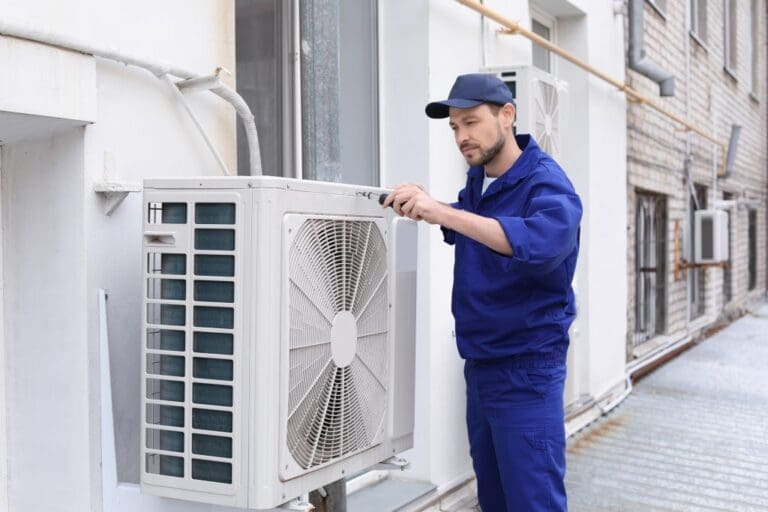a guy checking outer of hvac system