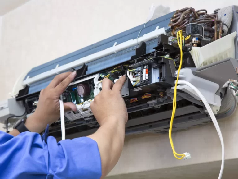 a person is repairing ac indoor unit.