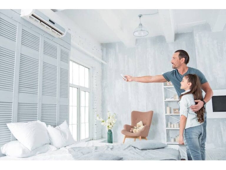 a couple watching at air conditioner and the man turning on air conditioner with remote.