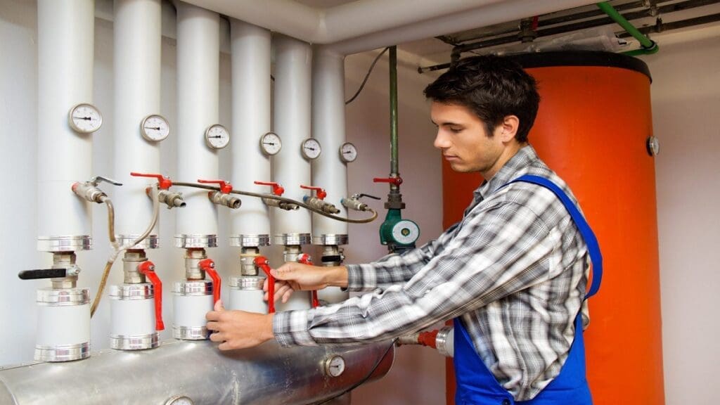 a technician is replacing boiler pressure relief walls