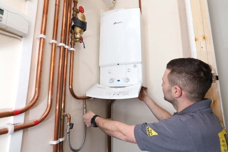 a technician installing boiler system at home.