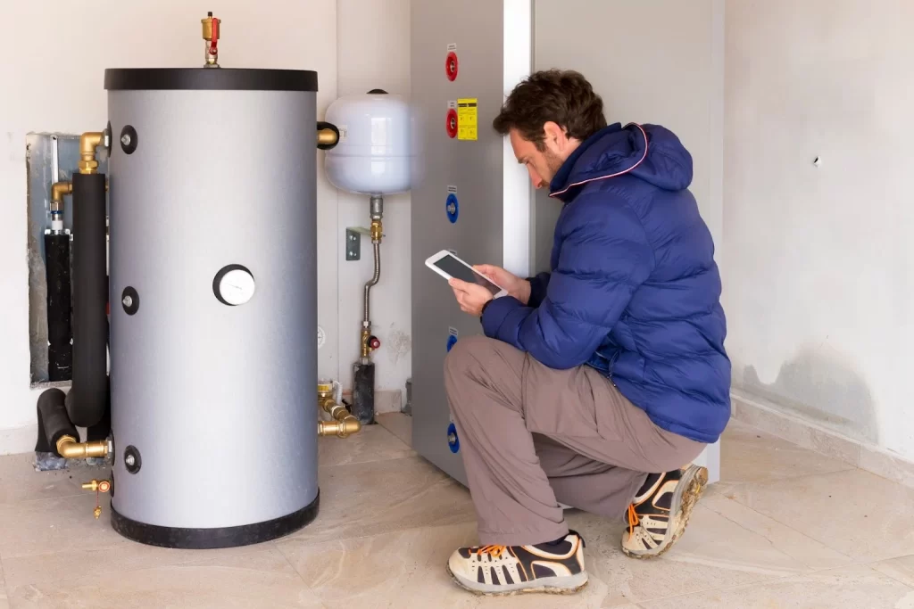 a technician installing boiler system at home.