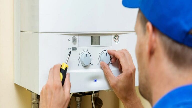 a technician repairing boiler system at home.