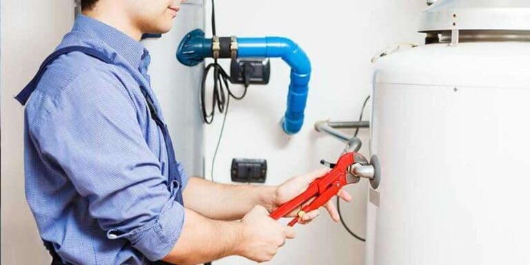 a technician installing boiler and he is putting wrench on a bolt.