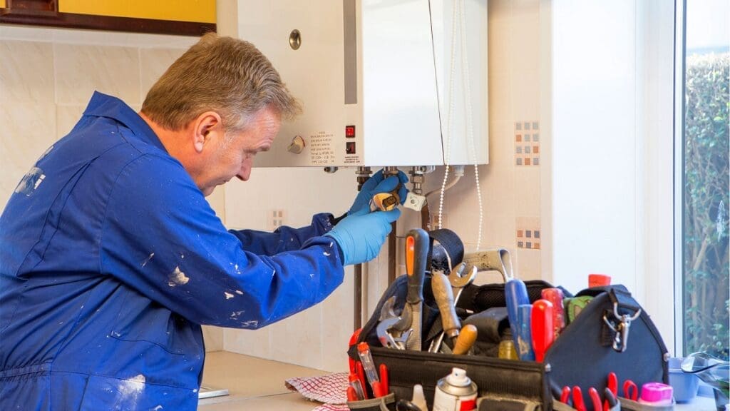 a technician repairing boiler system of a home.