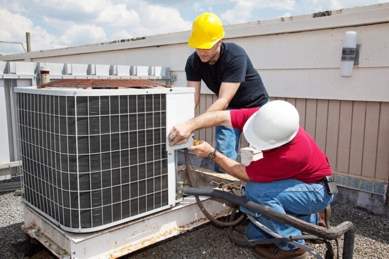 technicians repairing chiller outdoor system.