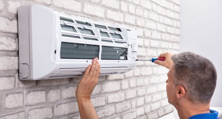 a technician repairing air conditioner.