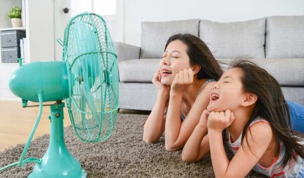 Mother and daughter enjoy a fan