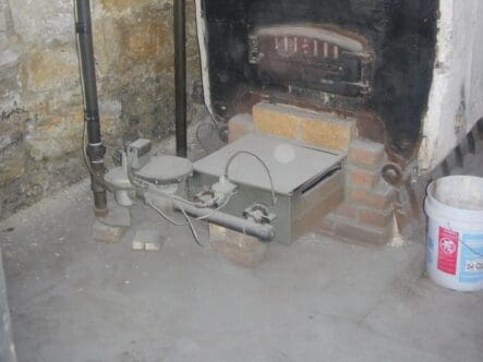 an old boiler sits in a basement of a home